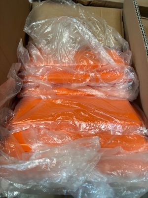 a box full of carrots wrapped in plastic