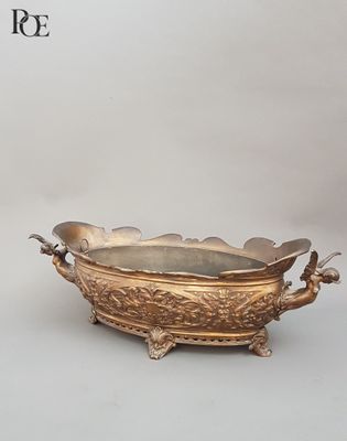 a gold bowl with two birds on it