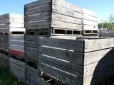 de nombreuses caisses en bois empilées les unes sur les autres dans l'herbe