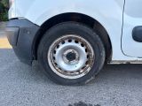 a white van with a flat tire parked on the street