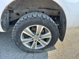 a close up of a tire on a white truck