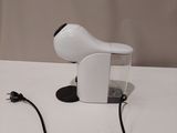 a hair dryer sitting on a table with a cord