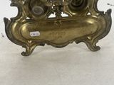 an image of a brass plate with a clock on it