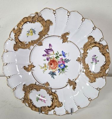 a white plate with gold trim and flowers on it
