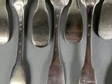 a lot of forks and spoons that are on a table