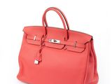 a red leather handbag on a white background