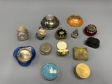 several different types of silver and gold jewelry on a gray surface