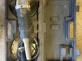 a tool in the case that is sitting on the floor