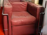 a red couch and chair in a room with a red carpet
