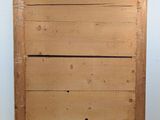 a wooden dresser with a mirror on top of it
