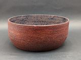 a red bowl sitting on top of a table