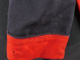 a close up of a black jacket with red trims on a mannequin head