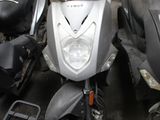 many scooters that are parked in a parking lot