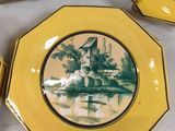 yellow plates with a picture of a windmill on them on a table