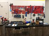 many tools hanging on the wall in this garage