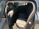 the back seat of a car with the door open and the passenger seat down