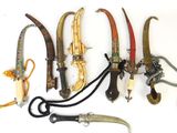 five different types of knives and a pair of scissors on the table