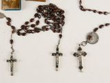 a bunch of rosary beads and a book on a table