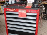 the tool cabinet is red and black in color