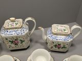 five pieces of porcelain tea and coffee set on a table