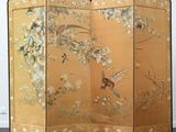 a room divider that has a bird and flowers on it