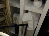 a chair and a shelf in the corner of a room