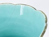 a close up of a blue bowl on a white surface