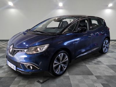 a blue car is parked on a checkered floor in a garage