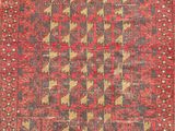 a red and black rug with a geometric design on it