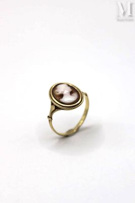 an image of a gold ring with a picture of a woman ' s face on it