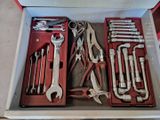 many tools in a tool box on the floor