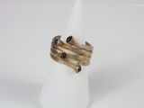a close up of a gold ring with garnets on top of it