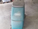 an image of a blue machine is sitting in a garage