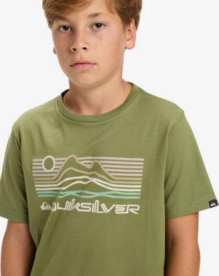 un garçon portant un t-shirt vert orné d'un motif représentant une montagne