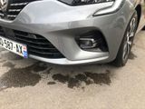 the front of a silver car parked in a parking lot