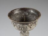 an antique silver cup with a decorative decoration on the base