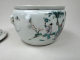 a white bowl with a design on it next to a plate