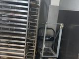 several trays of food sit on a rack in a kitchen