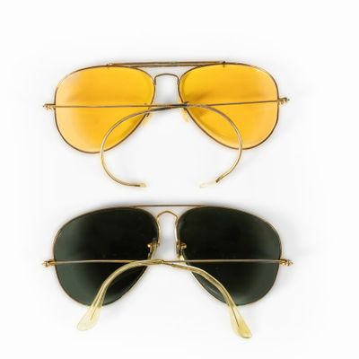 two pairs of yellow and black sunglasses on a white background