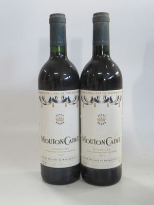 two bottles of wine sitting next to each other on a table