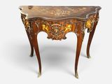 a small table with a marble top and gold decoration