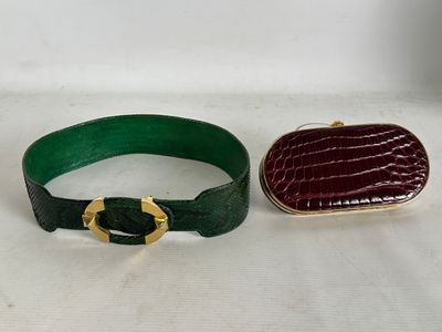 two pieces of green and red leather with a gold buckle