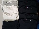 a lot of t - shirts sitting on a table together