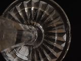 a close up of a wine glass being filled with water