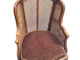 an image of a chair with a cane back and a brown seat