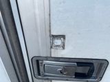 a close up of a door handle on a white door