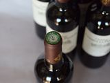 several bottles of wine are lined up on a table