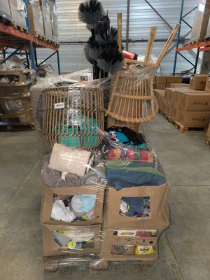a pile of boxes and a bird cage in a warehouse