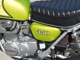 a green and black motorcycle parked in a parking lot