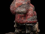 an image of a sculpture of a dog with a basket on it ' s head